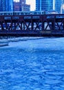 Elevated `el` train speeds over a blue and frozen Chicago River Royalty Free Stock Photo