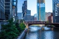 Elevated `el` train and water taxi carry commuters, along with pedestrians walking during morning commuter over Chicago River