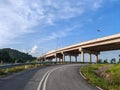 Elevated Highway with Concrete Pillars in Forested Area Royalty Free Stock Photo