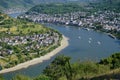 Elevated landscape view of the Rhine River, town of Boppard and four jet skiers speeding along the winding river.