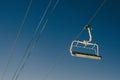 Elevated passenger ropeway on a sunny day with a blue sky in the background Royalty Free Stock Photo