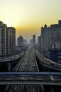 Elevated road in Shanghai. The sun sets on the horizon, the sky and the clouds / smog glow in warm orange tones.