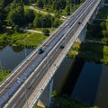 Elevated roadway with multiple lanes spanning a river, divided by a central barrier. Royalty Free Stock Photo