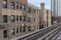 Elevated train tracks alongside vintage brick apartment buildings in Chicago