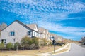 Elevated two and three story houses in slope along residential street of new development suburban single family home in upscale Royalty Free Stock Photo