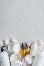 elevated view of bottles of cream natural oils and marshmallows on white surface