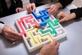 Group Of Businesspeople Solving Maze Puzzle