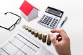 Elevated View Of A Businessperson`s Hand Stacking Coins