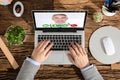 Elevated View Of A Businessperson Video Conferencing With Doctor