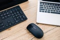 elevated view of computer keyboard, computer mouse and laptop Royalty Free Stock Photo