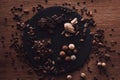 elevated view of cutting board with various types of chocolate pieces and truffles surrounded by cocoa beans, coffee grains and