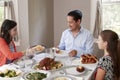 Elevated view of Jewish family serving food at Shabbat meal