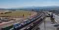 Elevated View of Long Freight Train on Tracks in Barstow, Route 66, with Scenic Mountain Backdrop Royalty Free Stock Photo