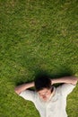 Elevated view of a man lying with his eyes closed and his head r Royalty Free Stock Photo