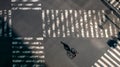 Elevated view over a biker man on pedestrian crossing in road intersection Japan Royalty Free Stock Photo