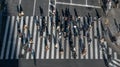 Elevated view over crowd pedestrian crossing in road intersection at day