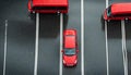 Elevated view over the front driving red car through the covered with