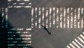 Elevated view over a man using smartphone on pedestrian crossing road at Japan