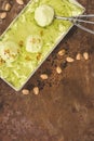 elevated view of pistachio ice cream with scoop and pistachios