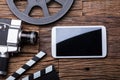 Elevated View Of Smartphone With Movie Camera And Film Reel Royalty Free Stock Photo