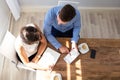 Two Businesspeople Examining Invoice On Digital Tablet Royalty Free Stock Photo