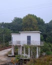 Elevated White Twin?Unit Cabin on Stilts With Curving Access Road Royalty Free Stock Photo