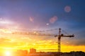 Elevating construction crane against the background of the sunset sky. Royalty Free Stock Photo