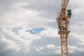 Elevating crane and sky with clouds