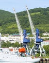 Elevating cranes in sea port on Kamchatka Royalty Free Stock Photo