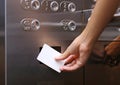 Elevator access control, Hand holding a key card to unlock elevator floor befor up or down