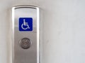 Elevator button with blue disabled people sign on elevator panel Royalty Free Stock Photo