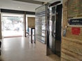 Elevator doors, close lift cabin entrance with chrome metal buttons panel, empty building interior, hotel or dwelling lobby