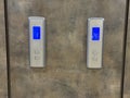 Elevator floor display panels with numbers on textured wall background Royalty Free Stock Photo