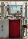 Elevator glass and chrome metal with closed red door in department store for lifting people to the upper floors with push switch