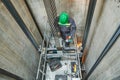 Lift machinist repairing elevator in lift shaft Royalty Free Stock Photo