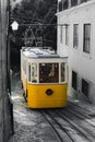 Elevator in Lisbon. Yellow black and white. Old town tram. building Windows trees