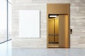 Elevator with open doors and a blank billboard against a marble wall. Royalty Free Stock Photo