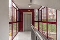 An elevator in a retrofit residential building with an external metal