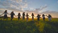 Eleven cheerful girls run to the meeting across the field in the summer, holding hands. Royalty Free Stock Photo