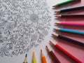 Colored pencils around a mandala