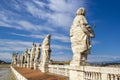 Eleven statues of the saints apostles standing on the roof of Saint Peter`s Basilica in Vatican City, Rome, Italy, back view