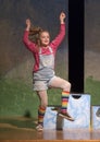 Eleven-year old girl dancing on stage in school play