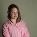 Eleven year old girl in oversized pink blouse Royalty Free Stock Photo