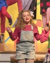 Eleven-year old girl singing on stage in school play