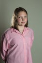 Eleven year old girl in oversized pink blouse Royalty Free Stock Photo