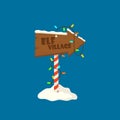 Elf Village Christmas Signboard, Wooden Sign with Snow and Garlands. Wood Banner, Road Direction Arrow on Striped Pole Royalty Free Stock Photo