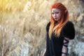 Elf women with fiery hair on nature.