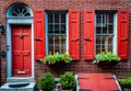 Elfreth`s Alley a historic street from colonial era in Old City, Philadelphia. House with red door and red window`s shutters.