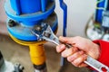 Elimination of a problem in the boiler room of an apartment building. The process of connecting pipes and tightening nuts with an Royalty Free Stock Photo