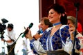 Elisabeta Turcu singing on a stage in Italy.